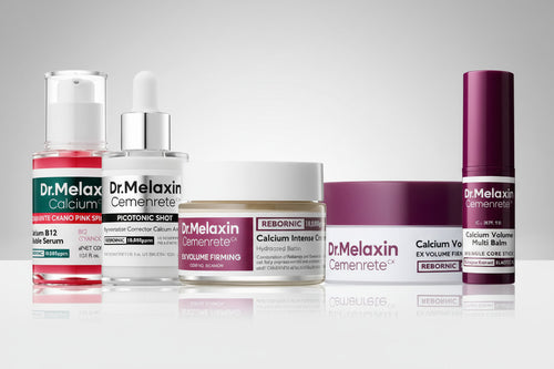 Collection of Dr. Melaxin skincare products on a reflective surface with a gray background