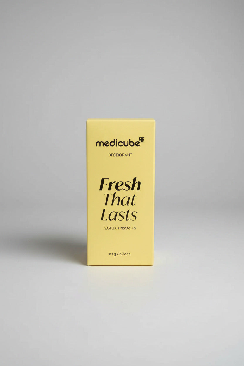 Yellow Medicube deodorant box on a desk with a laptop and keyboard in the background